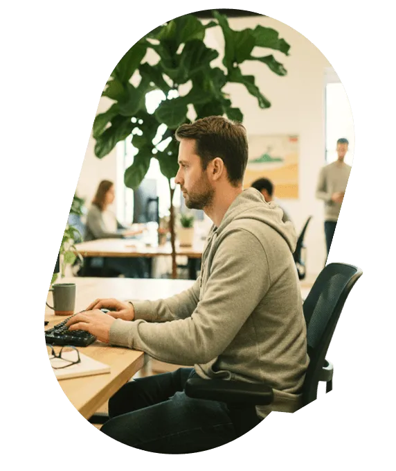 A developer working at a computer in a bright open-plan office
