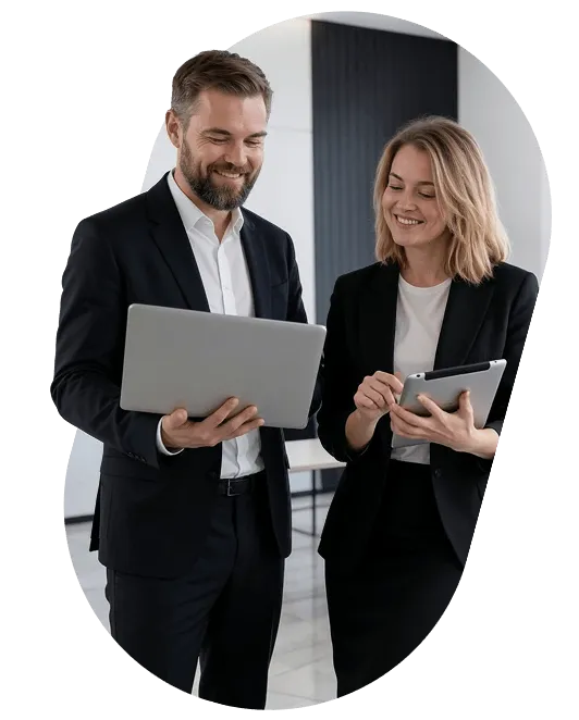 Two business professionals reviewing a laptop and a tablet together