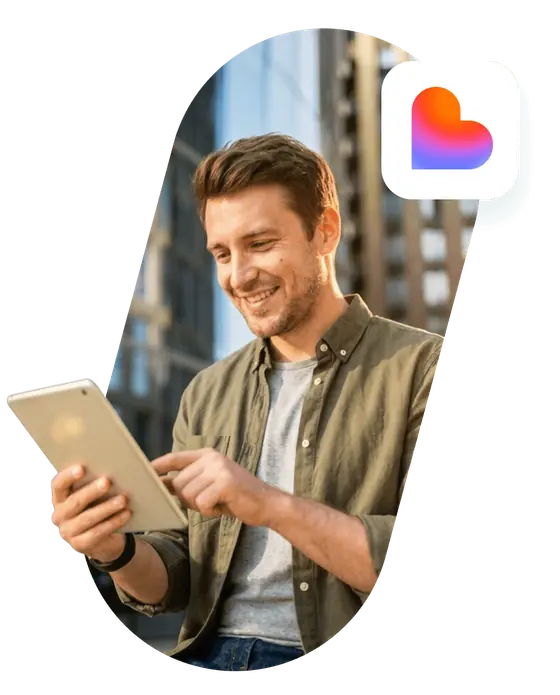 A smiling founder using a tablet, next to the Lovable logo