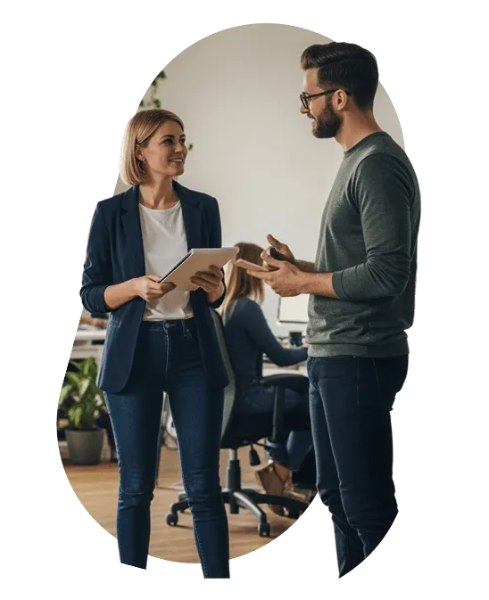 Two colleagues discussing a plan on a tablet in an office